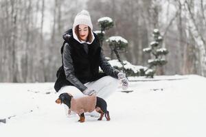 The girl walks with a dog in the winter. photo