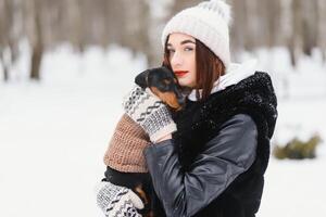 The girl walks with a dog in the winter. photo