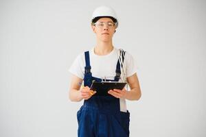 Full length of mid adult service man taking notes over white background photo