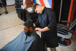 Young African-american man visiting barbershop photo