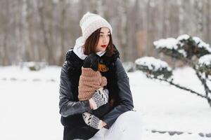 Woman is walking during winter with her dog photo