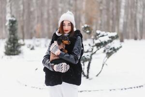 Woman is walking during winter with her dog photo