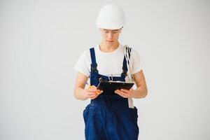 handsome electrical engineer holding clipboard on white background photo