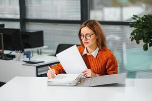 Portrait of smiling modern business woman in office photo