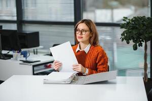 Confident business woman stands in the office photo