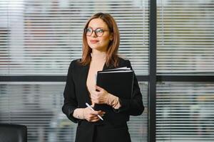 Smiling bank manager welcoming warm personality bright big smile in large building photo