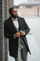 Portrait of an African American businessman wearing a suit standing in an outdoor business environment photo