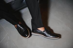 Stylish leather men's shoes on foot photo