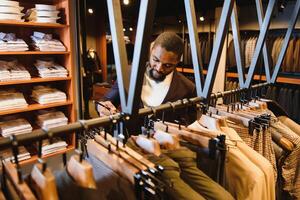 African American man, clothing store, chooses clothes photo