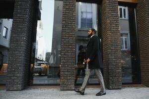 Portrait of an African American businessman wearing a suit standing in an outdoor business environment photo