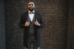 Portrait of an African American businessman wearing a suit standing in an outdoor business environment photo