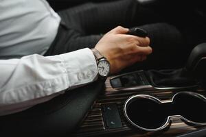 Close-up Of Person's Hand Changing Gear While Driving Car. photo