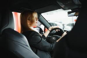 young beautiful business woman sitting in her car. photo