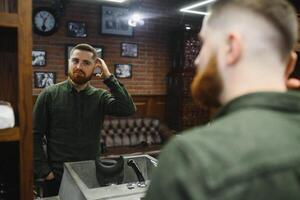 Barber at work. Collage of handsome bearded man getting haircut and beard grooming at barbershop. photo