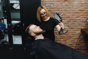 Client during beard shaving in barber shop photo