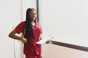 Portrait Of Smiling Female Doctor Wearing White Coat With Stethoscope In Hospital Office. photo