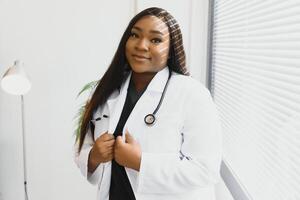 Portrait Of Smiling Female Doctor Wearing White Coat With Stethoscope In Hospital Office. photo