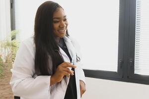 Portrait Of Smiling Female Doctor Wearing White Coat With Stethoscope In Hospital Office. photo