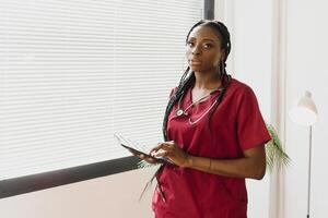 medicine, people and healthcare concept - african american female doctor or nurse at hospital. photo