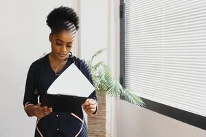 medicine, people and healthcare concept - african american female doctor or nurse at hospital. photo