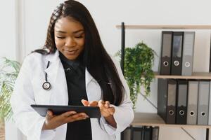 medicine, people and healthcare concept - african american female doctor or nurse at hospital. photo