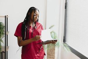 medicine, people and healthcare concept - african american female doctor or nurse at hospital. photo