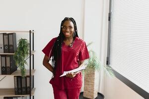 An African American female medical doctor with a stethoscope in hospital. photo