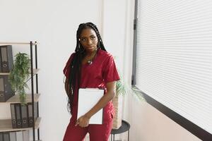 medicine, people and healthcare concept - african american female doctor or nurse at hospital. photo