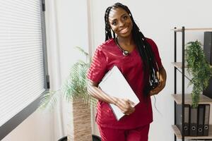 Portrait Of Smiling Female Doctor Wearing White Coat With Stethoscope In Hospital Office. photo