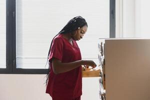 medicine, people and healthcare concept - african american female doctor or nurse at hospital. photo