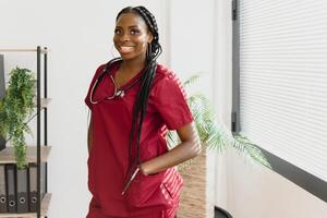 An African American female medical doctor with a stethoscope in hospital. photo