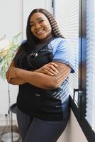 Young beautiful African American girl doctor in a white coat with a stethoscope. photo