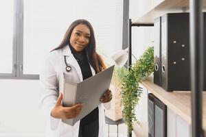 medicine, people and healthcare concept - african american female doctor or nurse at hospital. photo