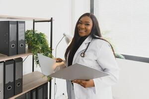 medicine, people and healthcare concept - african american female doctor or nurse at hospital. photo