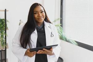 medicine, people and healthcare concept - african american female doctor or nurse at hospital. photo