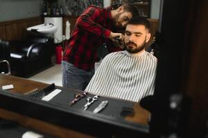 Men's haircut at the barber scissors. photo