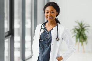 beautiful african american nurse with arms folded. photo