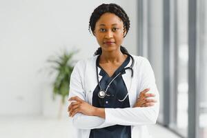 beautiful african american nurse with arms folded. photo
