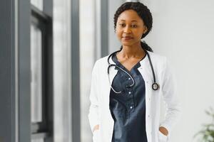 beautiful african american nurse with arms folded. photo