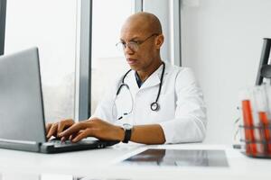 African American man male hospital doctor in white coat with stethoscope. photo