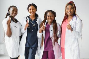 group of african doctor and nurse giving thumbs up. photo