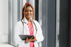 beautiful african american nurse with arms folded. photo