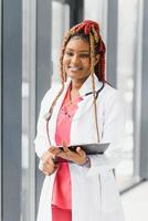 portrait of african female doctor at workplace. photo