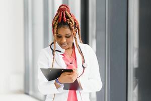 portrait of african female doctor at workplace. photo