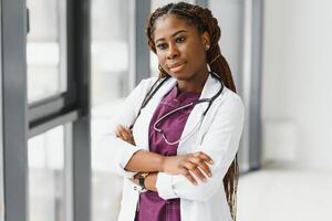 beautiful african american nurse with arms folded. photo