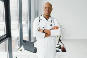 African American man male hospital doctor in white coat with stethoscope. photo