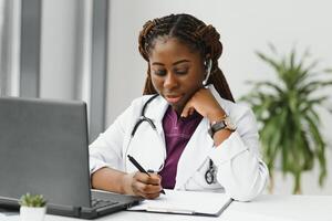 Pretty young smart female doctor or therapist giving health care advice online by webcam chat and consulting distant patient. Remote medical services. Telemedicine photo