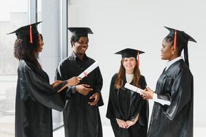 portrait of multiracial graduates holding diploma photo