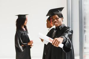 optimistic young university graduates at graduation photo