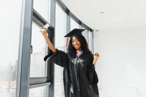 Excited African American woman at her graduation. photo